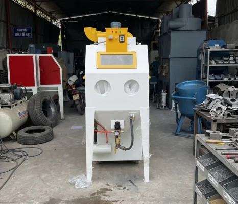 Máy phun bi / phun cát công nghiệp phục vụ làm sạch và tạo nhám bề mặt trước khi sơn phủ.